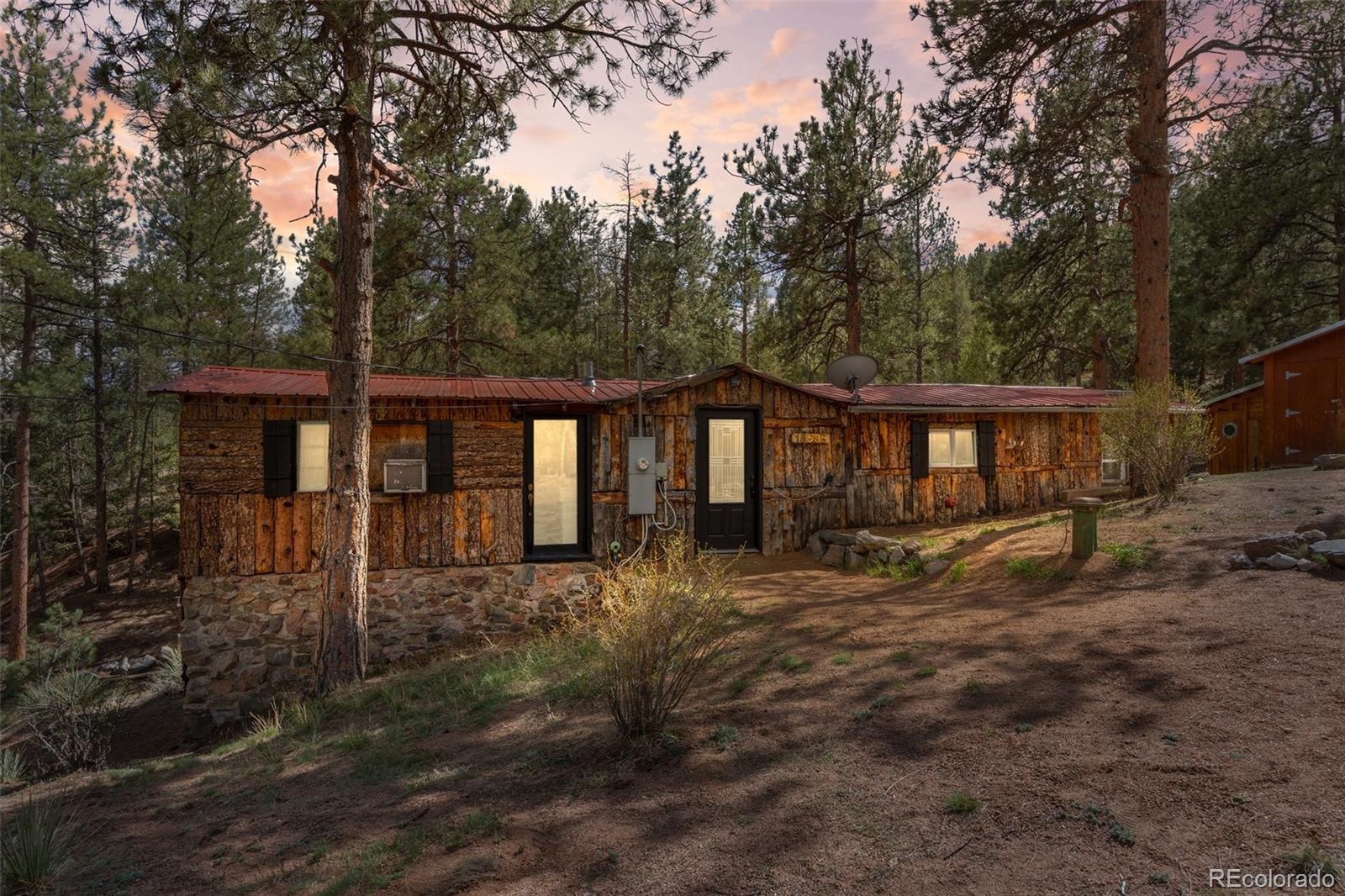 15535 South Elk Creek Road Pine, CO 80470 - Photo 25 of 25 a front view of a house with yard and trees around