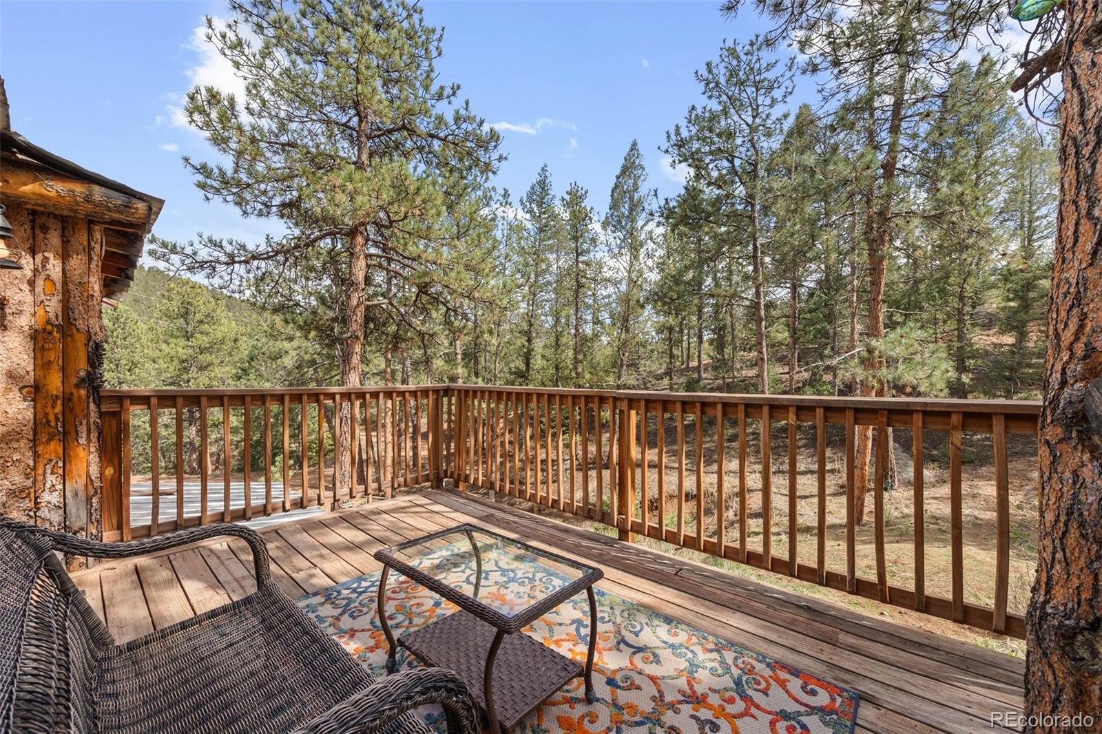 15535 South Elk Creek Road Pine, CO 80470 - Photo 4 of 25 a view of balcony with wooden floor and fence