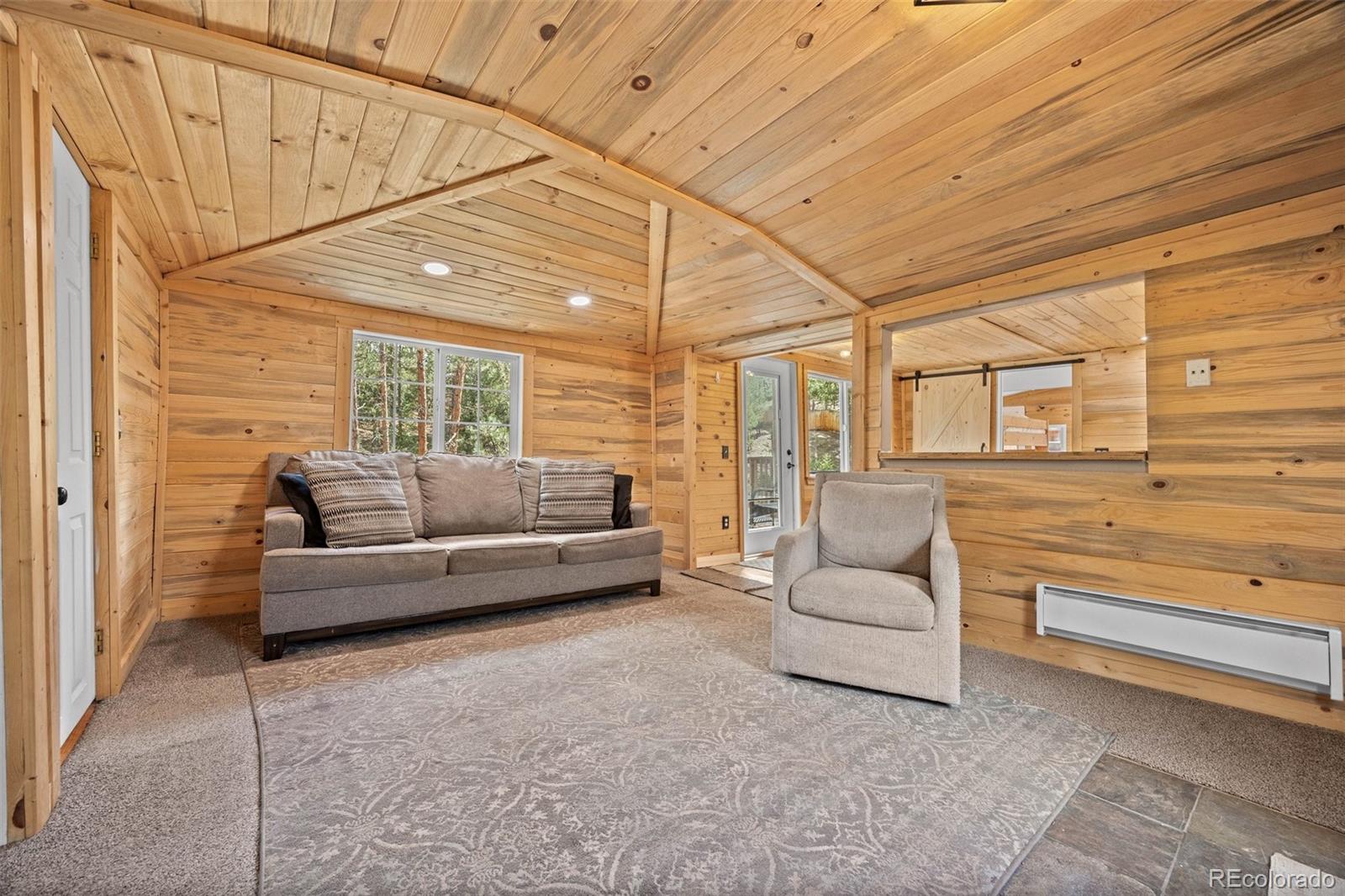15535 South Elk Creek Road Pine, CO 80470 - Photo 7 of 25 a living room with furniture and a large window