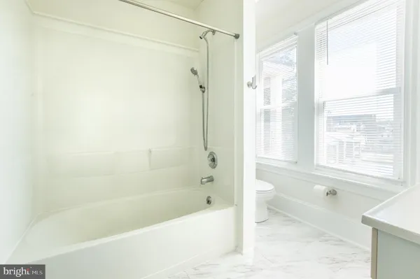 a bathroom with a sink a mirror and shower