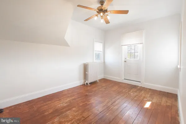 a front view of a building with a garden