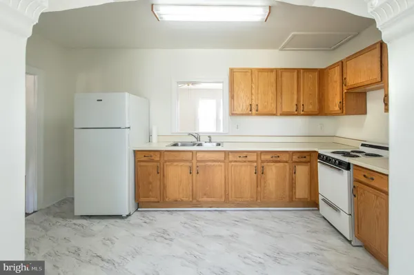 a kitchen with a stove and a white refrigerator