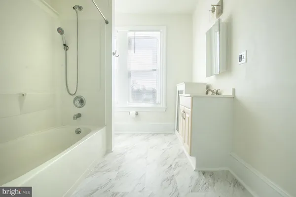 a bathroom with a bathtub shower and a toilet