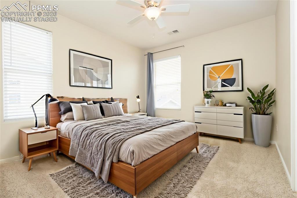4815 Harrier Ridge Drive Colorado Springs, CO 80916 - Photo 17 of 33 Bedroom with light carpet and a ceiling fan Virtually Staged