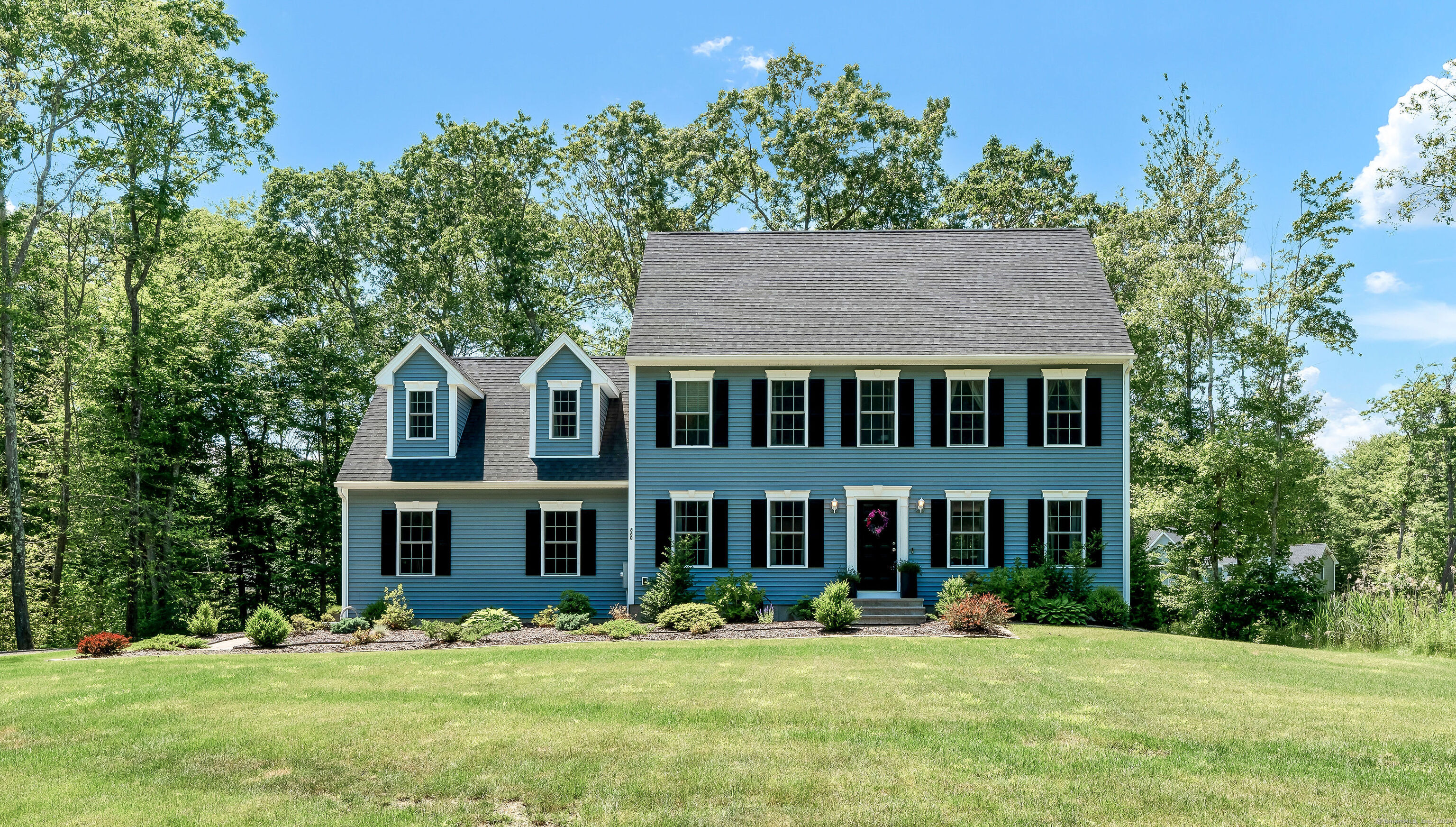 a front view of a house with a yard
