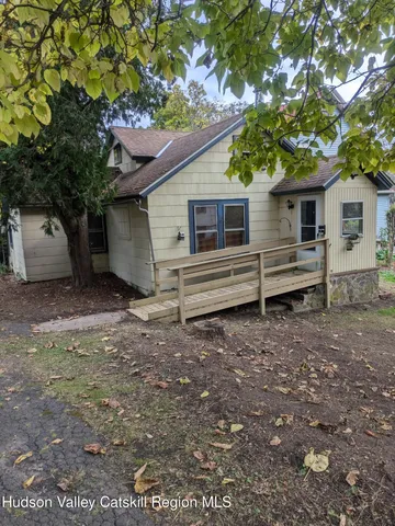 a small house with a tree in the yard