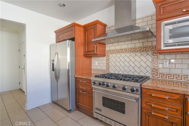 a kitchen with stainless steel appliances granite countertop a stove and a refrigerator