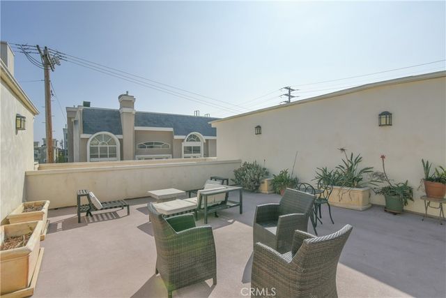a living room with furniture and potted plant