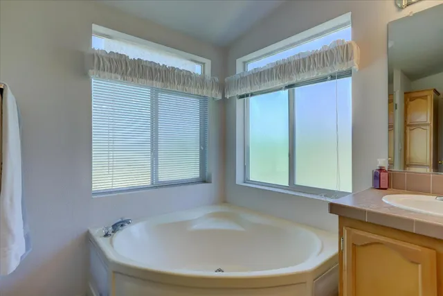 a bathroom with a tub and a sink