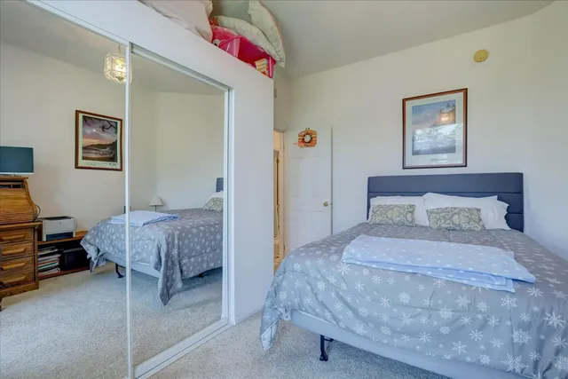 a bedroom with a bed and a dresser