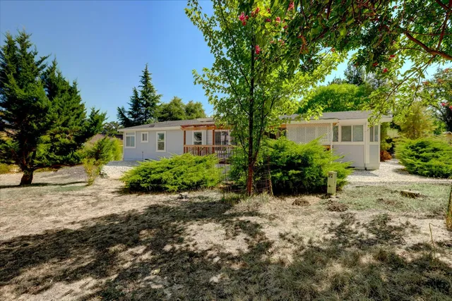 a view of a house with a yard and garage