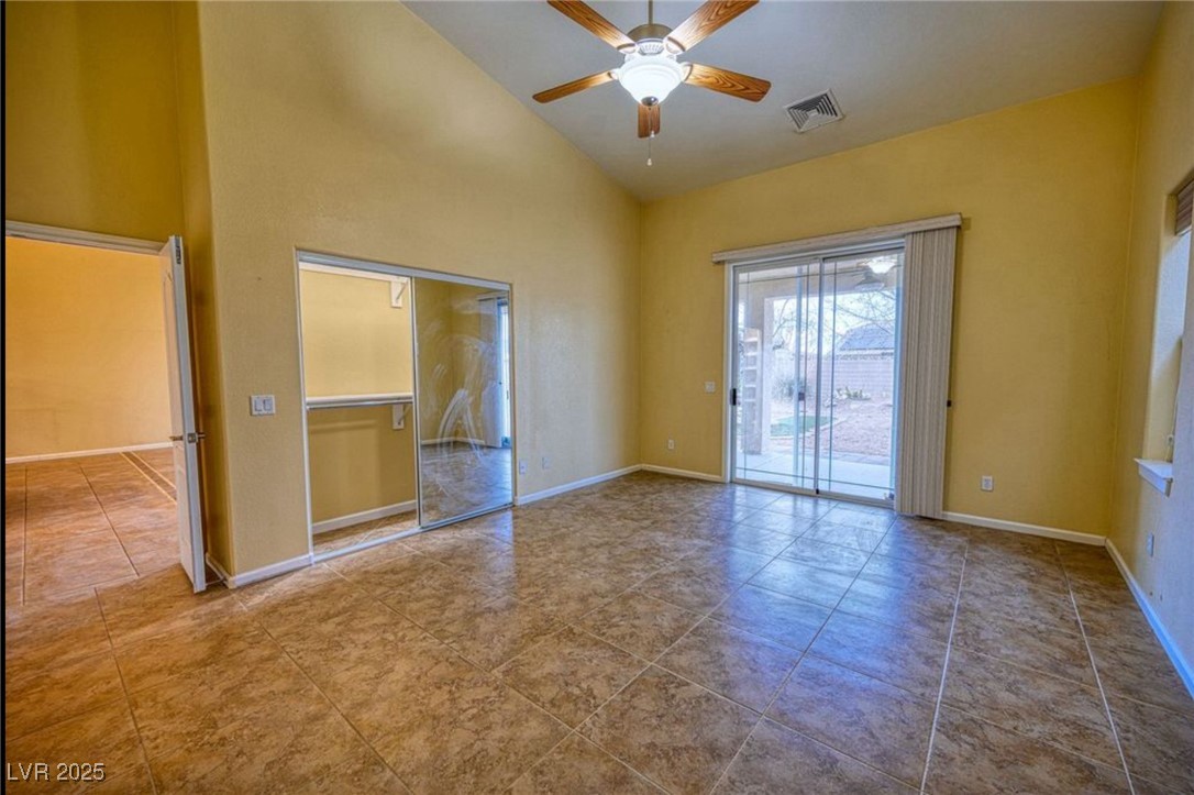 6780 Sandpebble Street Pahrump, NV 89061 - Photo 12 of 25 Spare room with high vaulted ceiling and a ceiling fan