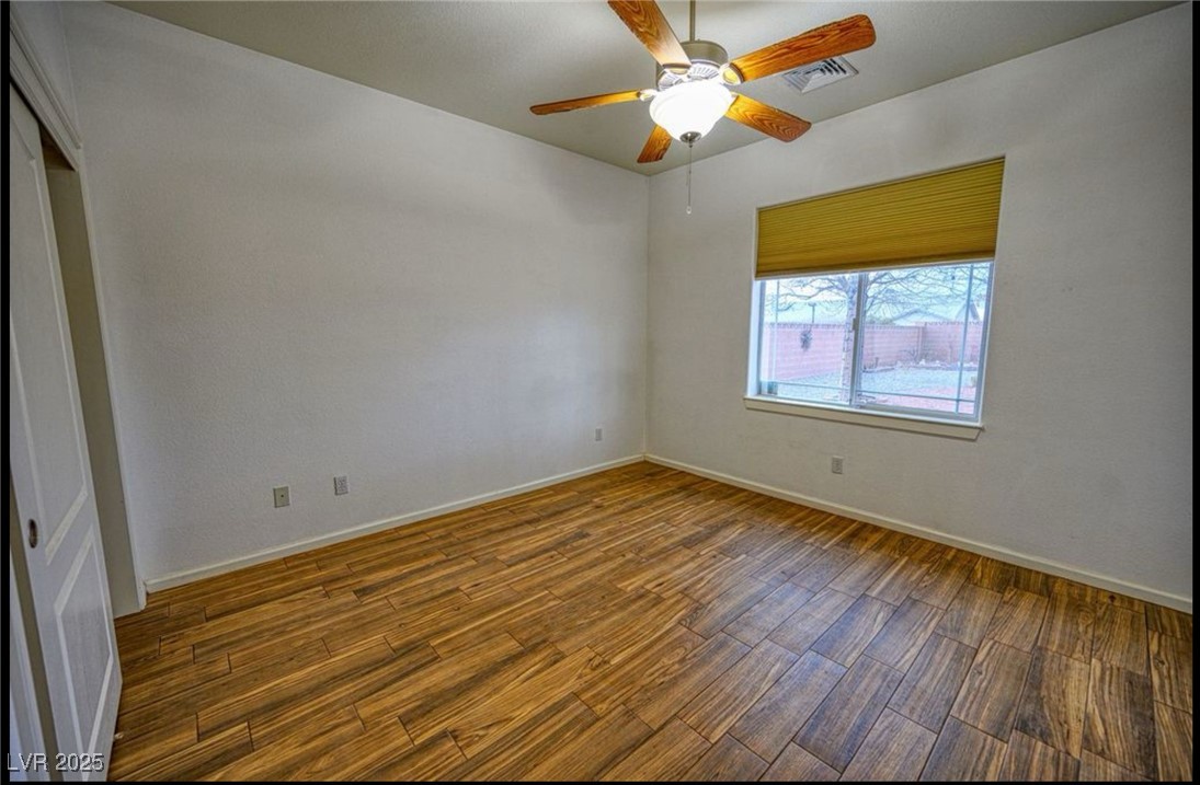6780 Sandpebble Street Pahrump, NV 89061 - Photo 6 of 25 Unfurnished room featuring wood finished floors and a ceiling fan