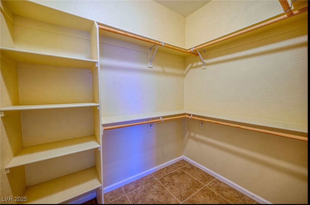 6780 Sandpebble Street Pahrump, NV 89061 - Photo 9 of 25 Walk in closet with tile patterned floors