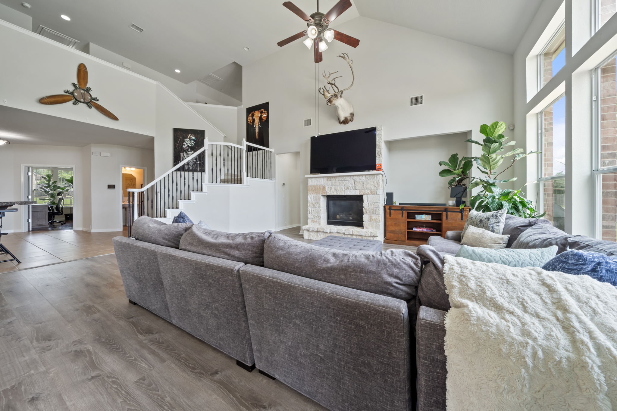 1581 Grassy Field Road Austin, TX 78737 - Photo 8 of 37 Soaring vaulted ceilings and a stone fireplace anchor this light-filled main living space.
