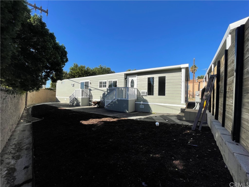 5803 Mission Riverside Ca, Unit 95 Riverside, CA 92509 - Photo 2 of 15 a view of a back yard of the house with a chair