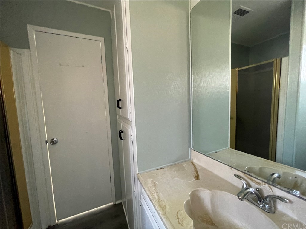 5803 Mission Riverside Ca, Unit 95 Riverside, CA 92509 - Photo 11 of 15 a bathroom with a granite countertop sink and shower