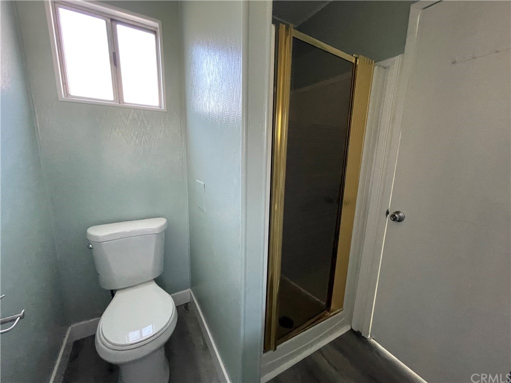 5803 Mission Riverside Ca, Unit 95 Riverside, CA 92509 - Photo 12 of 15 a white toilet sitting in a bathroom next to a window