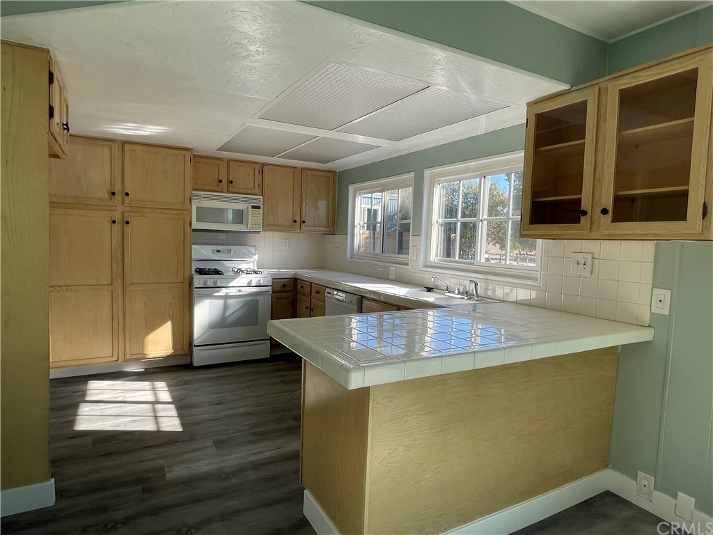 5803 Mission Riverside Ca, Unit 95 Riverside, CA 92509 - Photo 4 of 15 a kitchen with stainless steel appliances granite countertop a sink a stove and a refrigerator