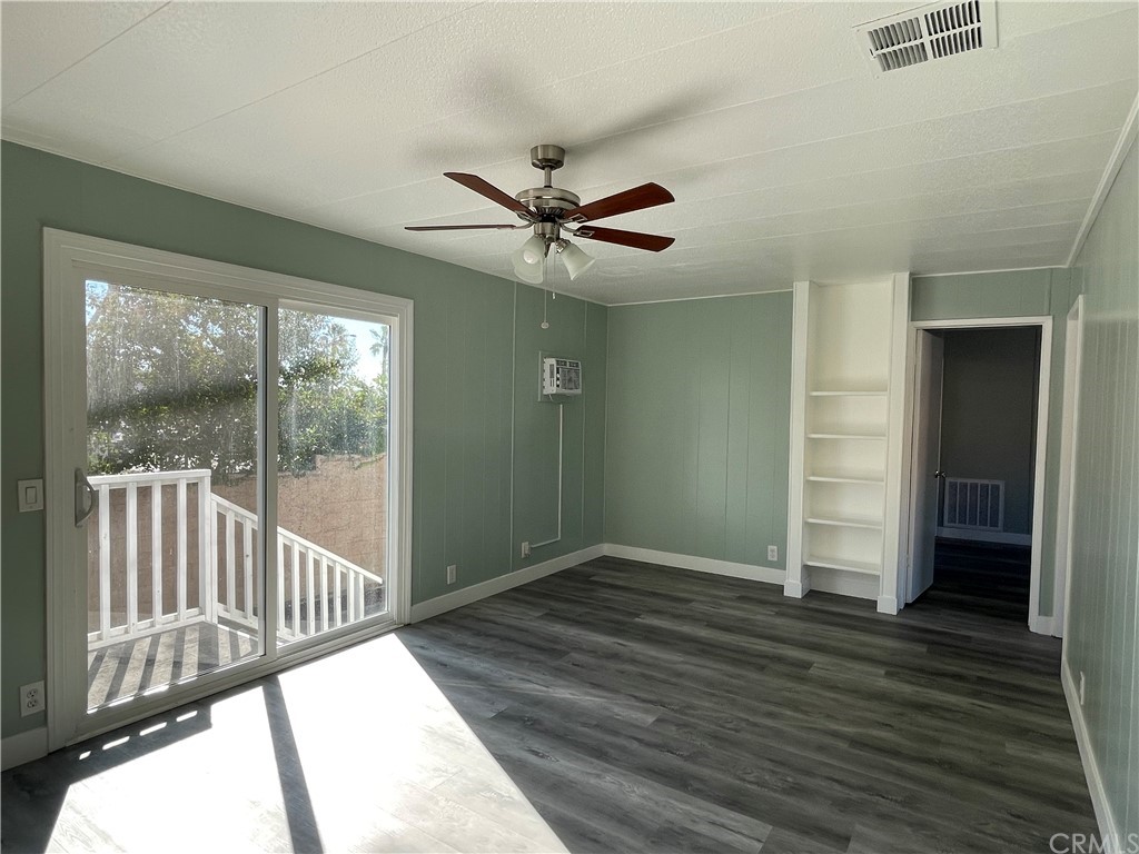 5803 Mission Riverside Ca, Unit 95 Riverside, CA 92509 - Photo 5 of 15 wooden floor in an empty room with a window