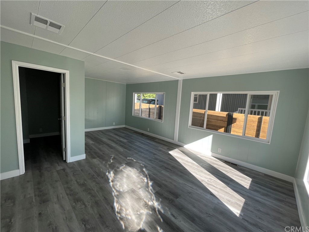 5803 Mission Riverside Ca, Unit 95 Riverside, CA 92509 - Photo 6 of 15 wooden floor in an empty room with a window