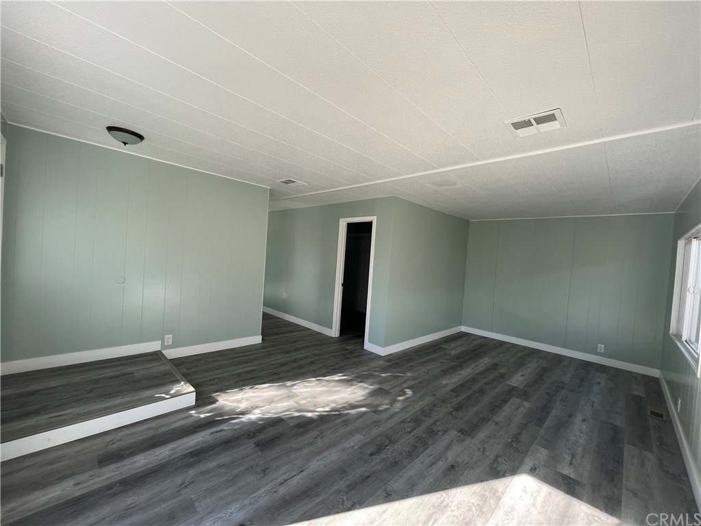 5803 Mission Riverside Ca, Unit 95 Riverside, CA 92509 - Photo 7 of 15 a view of wooden floor and window in a room