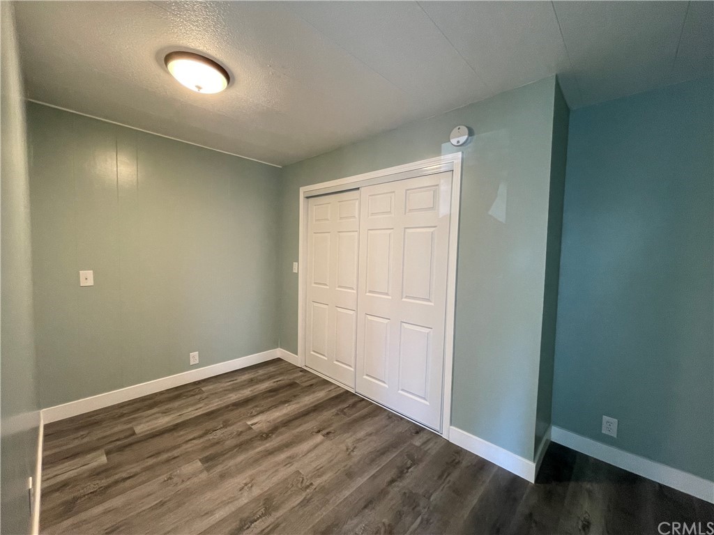 5803 Mission Riverside Ca, Unit 95 Riverside, CA 92509 - Photo 8 of 15 an empty room with wooden floor and windows