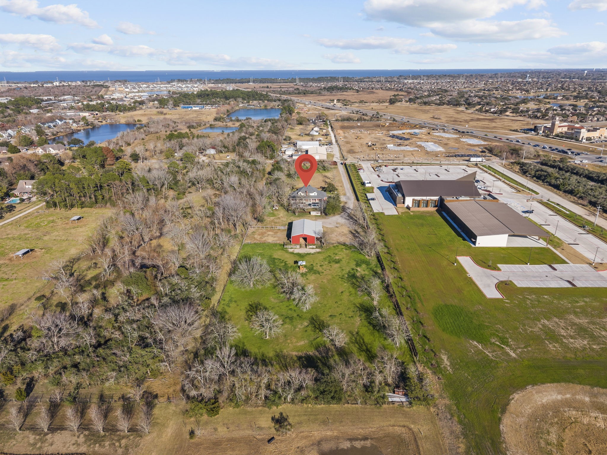 2730 Lawrence Road Kemah, TX 77565 - Photo 5 of 46 This aerial photo showcases a spacious property with ample greenery, a barn, and a house, offering privacy and a rural feel.
