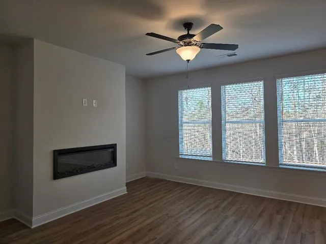 a view of kitchen with kitchen island a sink wooden floor and a refrigerator