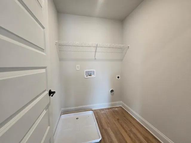 a view of hallway with wooden floor