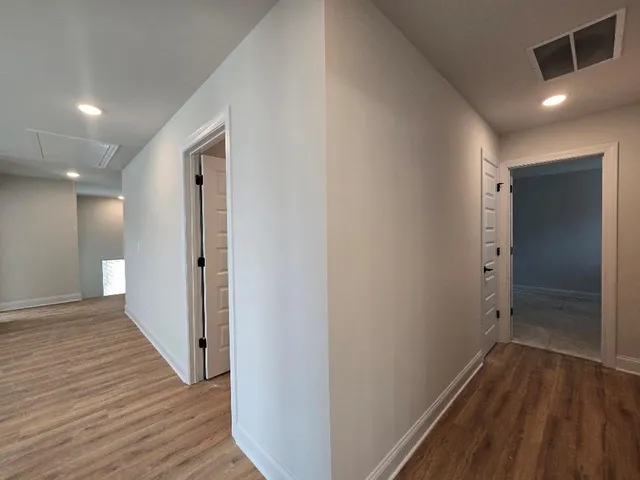 a spacious bathroom with a double vanity sink a mirror and a bathtub