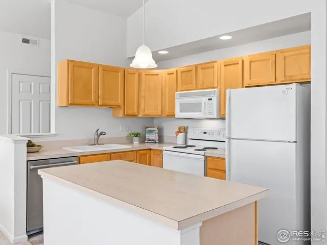 a kitchen with stainless steel appliances a refrigerator sink and cabinets