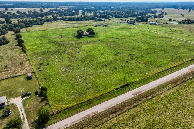 a view of a green field with an ocean view