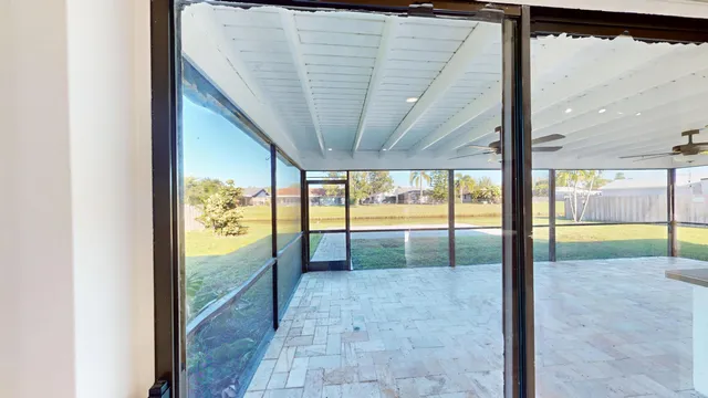 a view of a livingroom with wooden floor and a ceiling fan