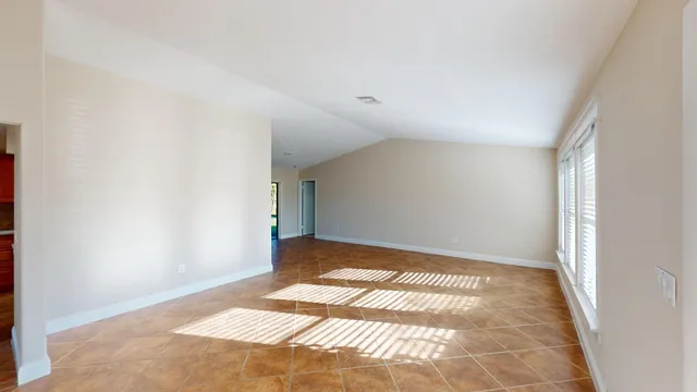 a view of an empty room with glass door