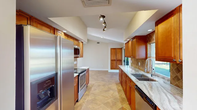 a kitchen with granite countertop a sink and a window