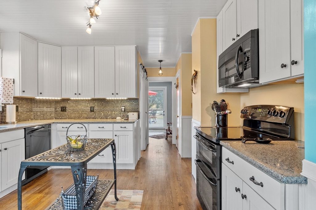 613 Petersham Road Athol, MA 01331 - Photo 22 of 41 a kitchen with stainless steel appliances granite countertop a stove refrigerator and cabinets