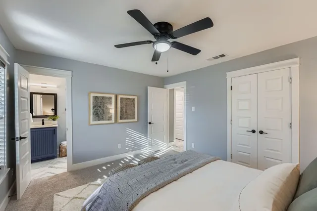 a bedroom with a bed and a chandelier