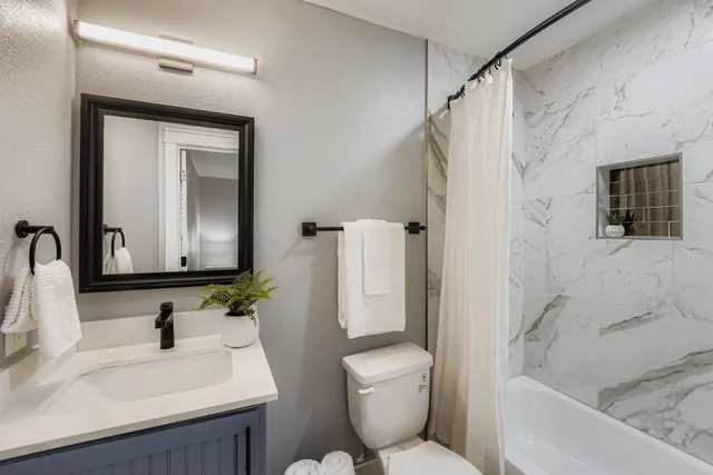 a bathroom with a sink toilet and shower