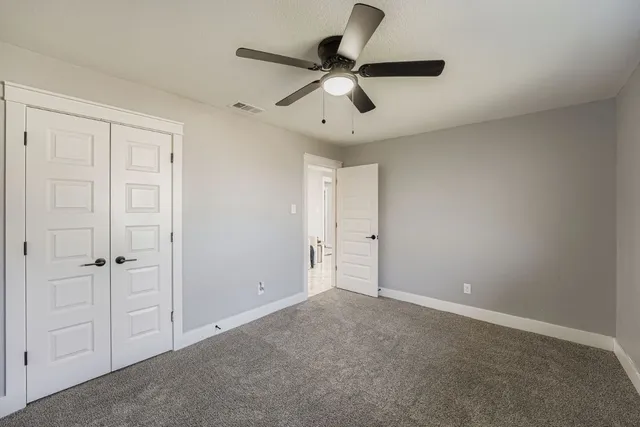 an empty room with ceiling fan