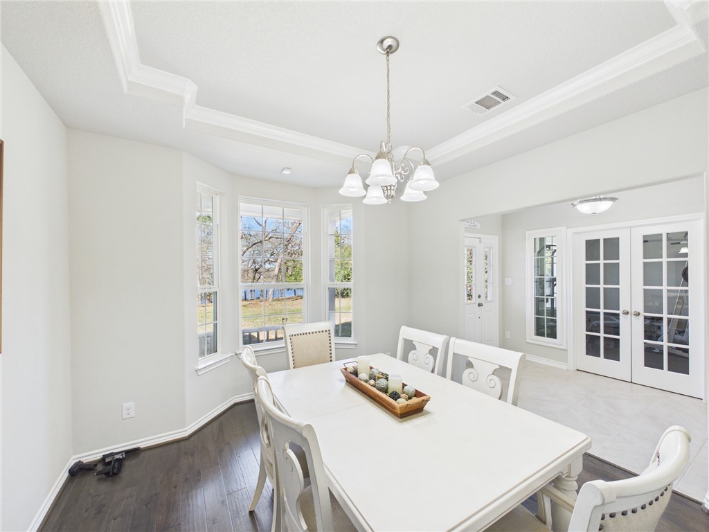 10645 C Hoppess Road Franklin, TX 77856 - Photo 15 of 50 a view of a dining room with furniture a chandelier and wooden floor