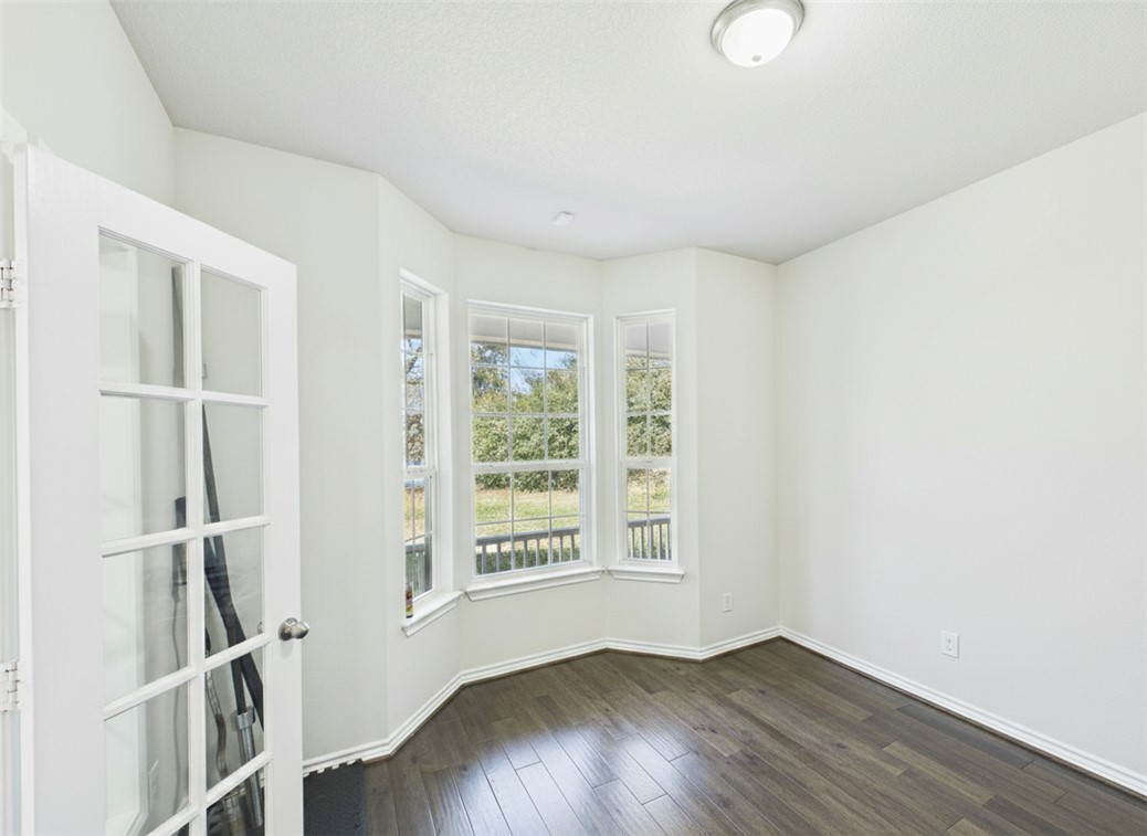10645 C Hoppess Road Franklin, TX 77856 - Photo 17 of 50 an empty room with wooden floor and windows