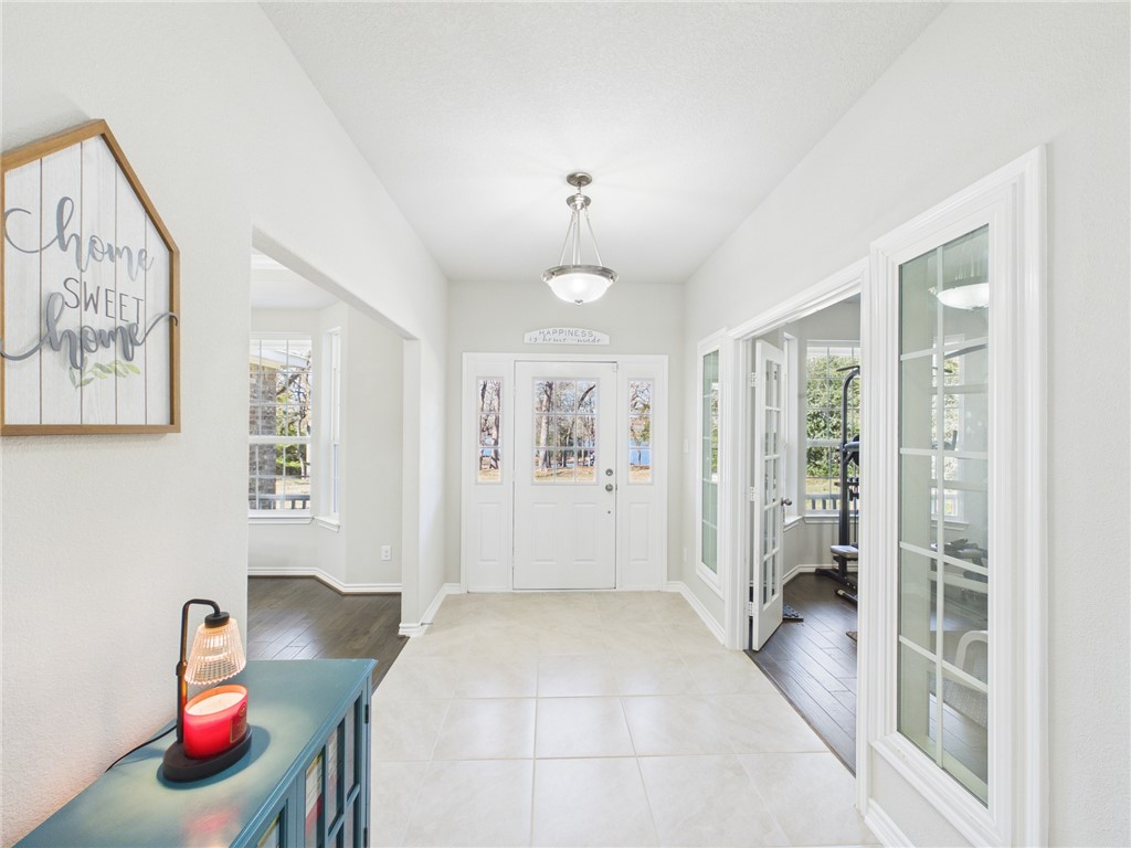 10645 C Hoppess Road Franklin, TX 77856 - Photo 19 of 50 a spacious bedroom with a bed and a chandelier