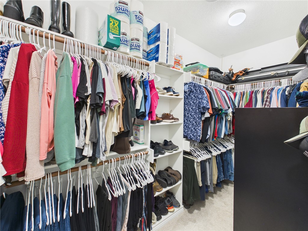 10645 C Hoppess Road Franklin, TX 77856 - Photo 21 of 50 a view of walk in closet with clothes and shoes