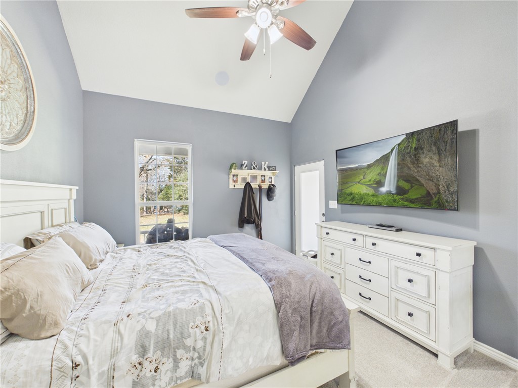 10645 C Hoppess Road Franklin, TX 77856 - Photo 23 of 50 a bedroom with a large bed and a flat tv screen on dresser