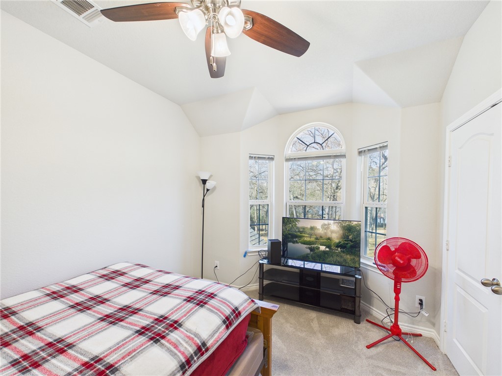 10645 C Hoppess Road Franklin, TX 77856 - Photo 31 of 50 a bedroom with a bed dresser and a window
