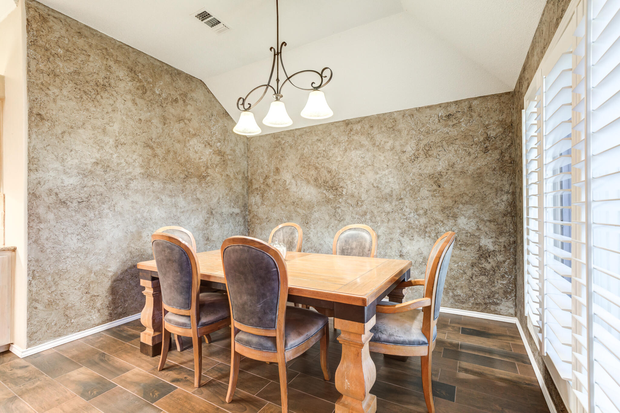 1 Squaw Lane Ransom Canyon, TX 79366 - Photo 35 of 74 a view of a dining room with furniture and wooden floor