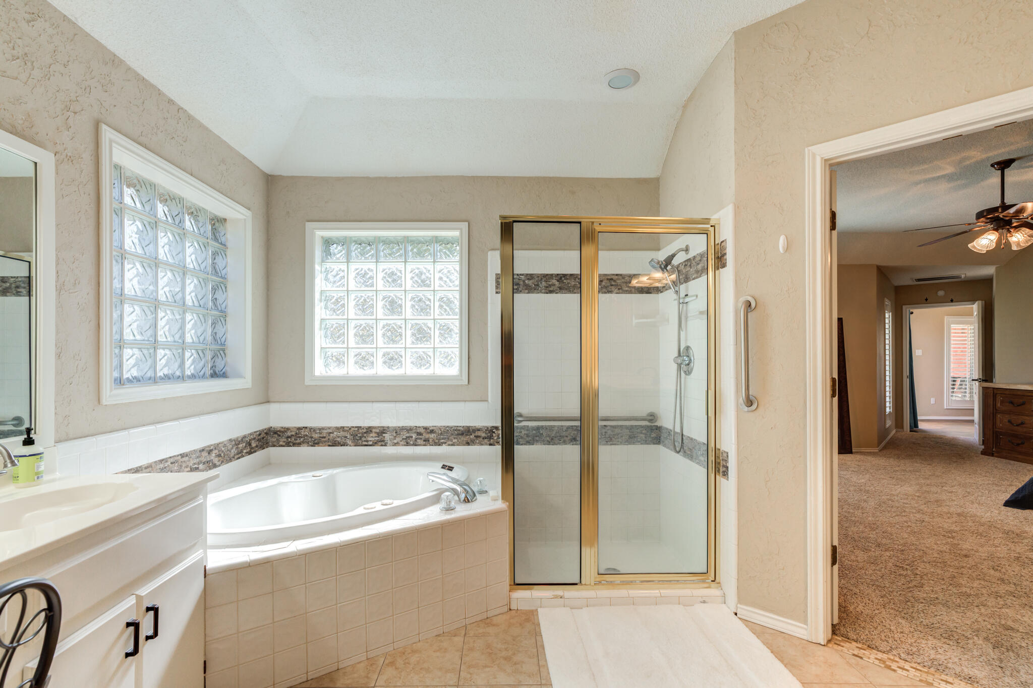 1 Squaw Lane Ransom Canyon, TX 79366 - Photo 41 of 74 a bathroom with a bathtub and a shower