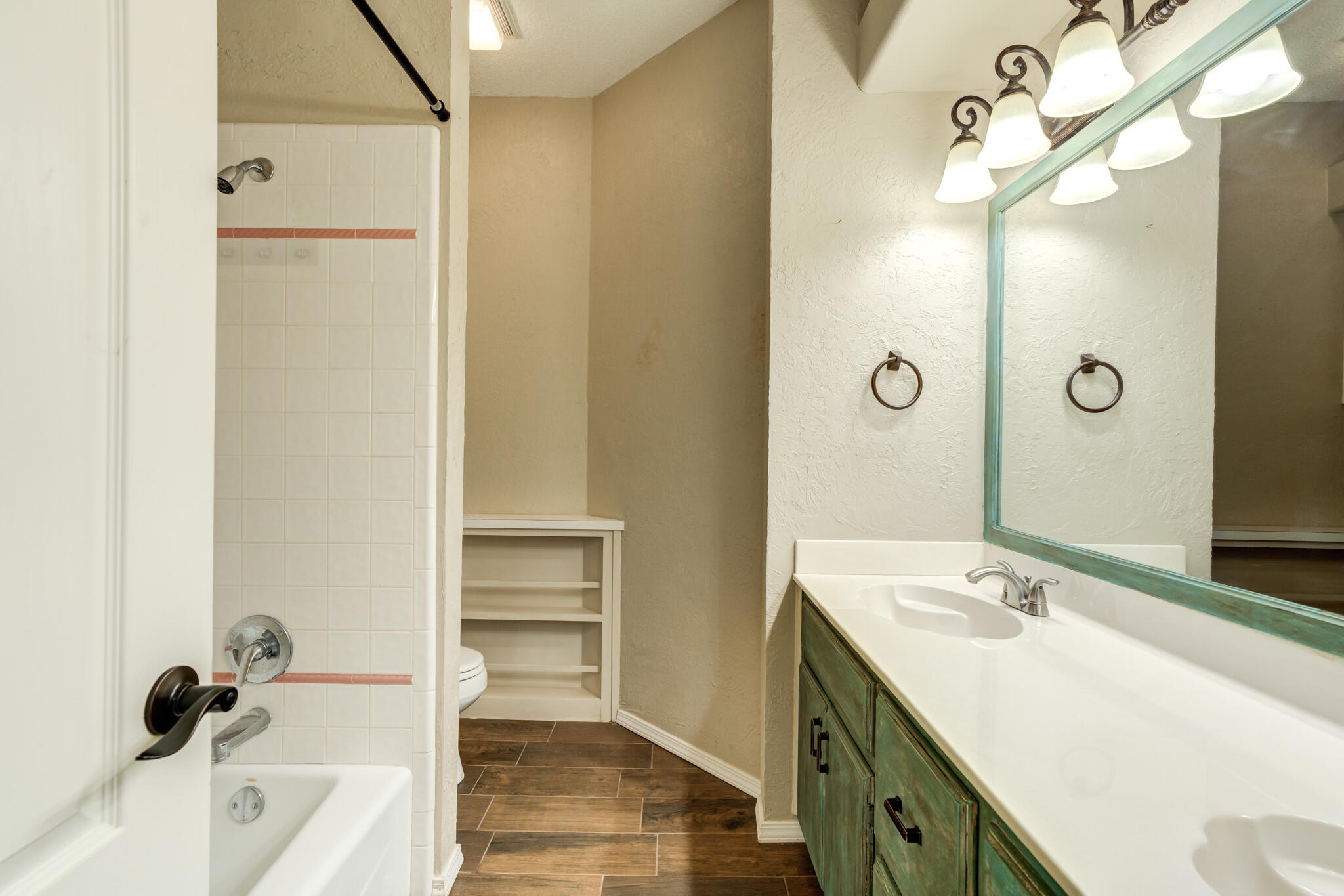1 Squaw Lane Ransom Canyon, TX 79366 - Photo 49 of 74 a bathroom with a tub sink vanity and a mirror