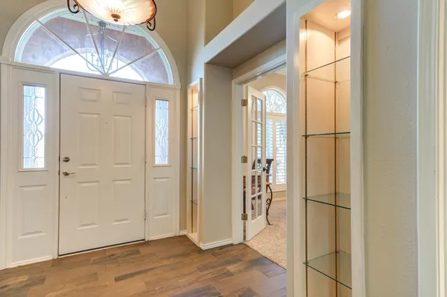 a kitchen with granite countertop white cabinets and stainless steel appliances